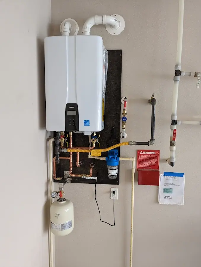 Professional plumber installing copper piping in a Oak Park home